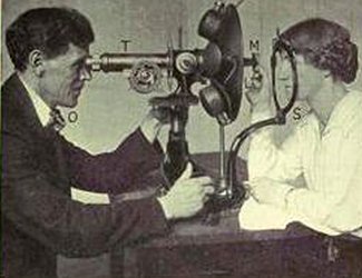 Dr. Bates tijdens een onderzoek met de retinoscoop